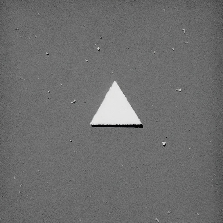 White Triangle on Rough Gray Surface with Debris