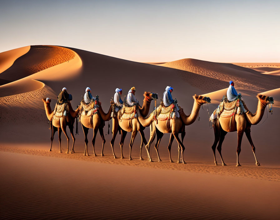 Camel caravan with riders crossing desert sand dunes.