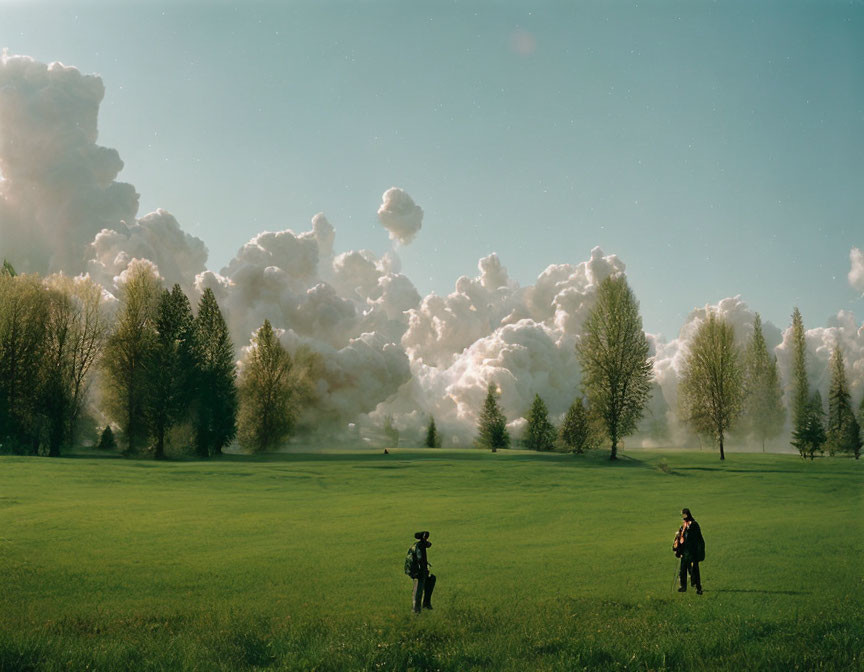 Tranquil landscape with two people in lush green field