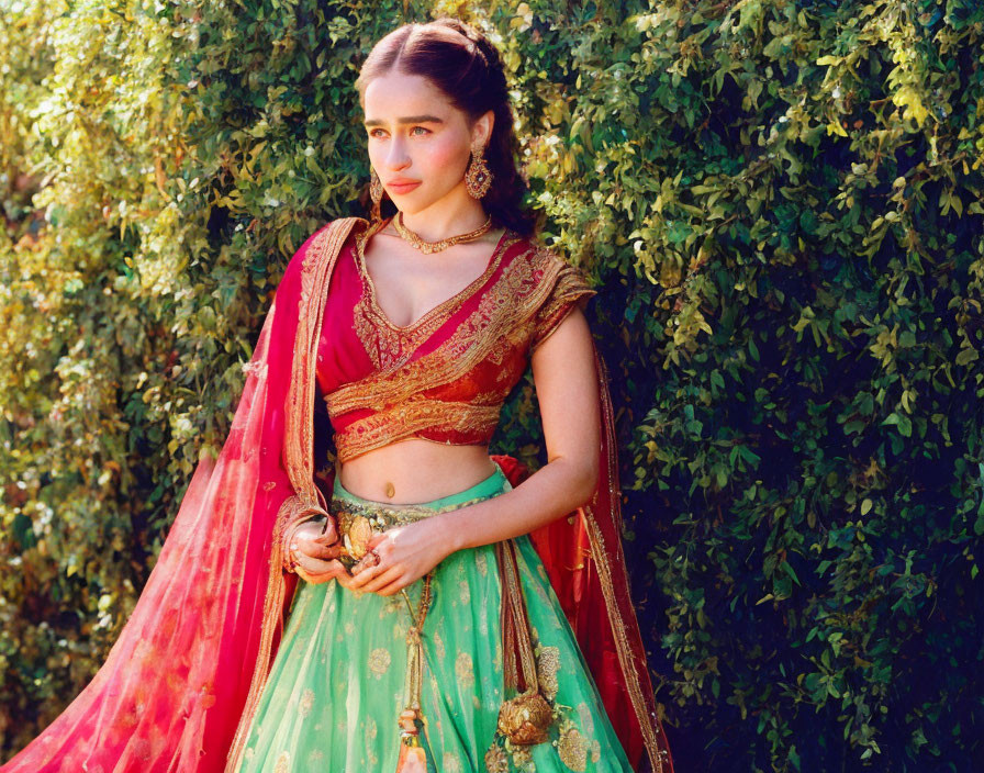 Traditional Indian Attire: Woman in Green and Pink Lehenga with Gold Jewelry