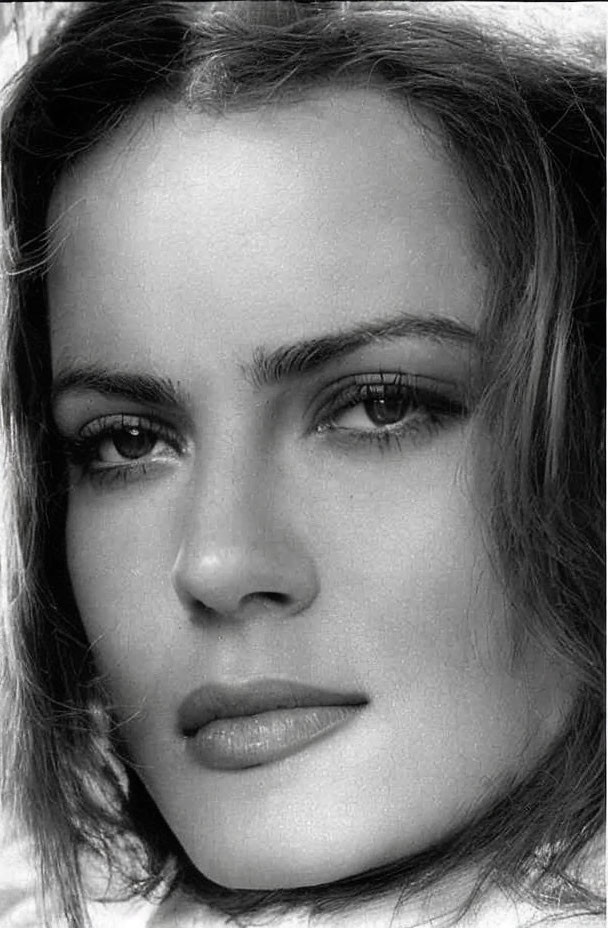 Monochrome close-up of woman with intense eyes and arched eyebrows