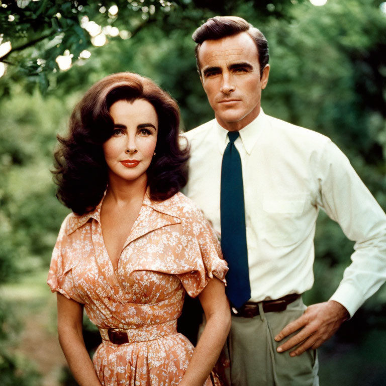 Dark-haired woman and man in yellow shirt and tie outdoors.