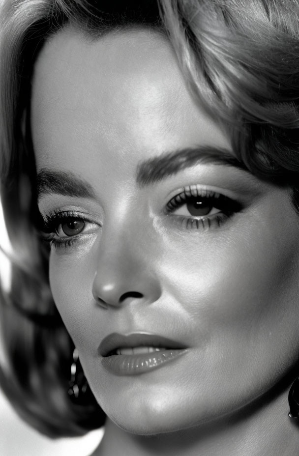 Monochrome close-up of woman with striking makeup