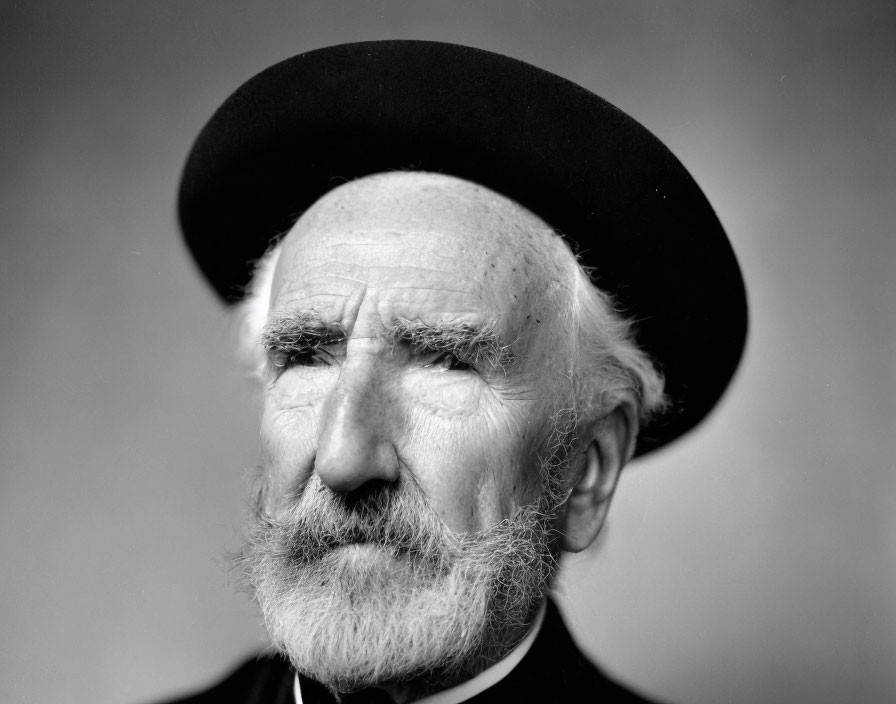 Elderly man in bowler hat with white beard in black and white portrait