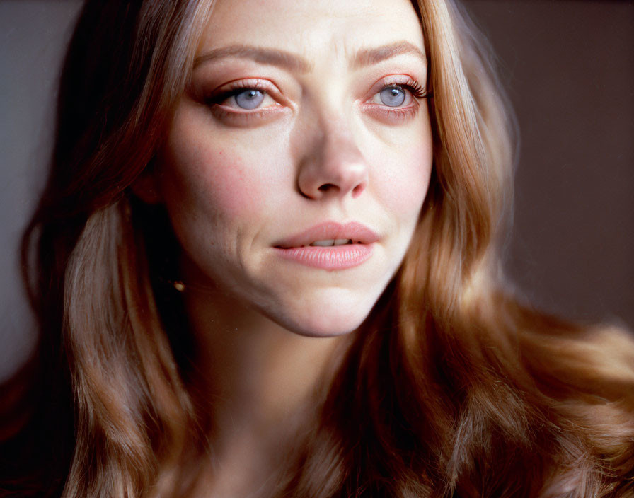 Portrait of woman with wavy hair and expressive blue eyes