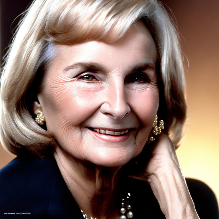 Elderly woman portrait with short blonde hair and pearl jewelry