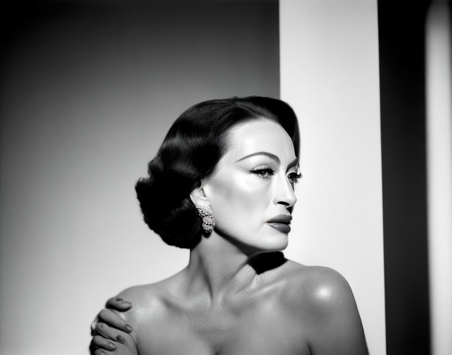 Monochrome portrait of woman with vintage hairstyle and large earrings