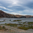 Tranquil lake with ancient ruins and lush greenery at dusk