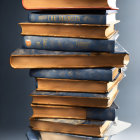 Antique Books Stack with Gold-Edged Pages on Gray Background