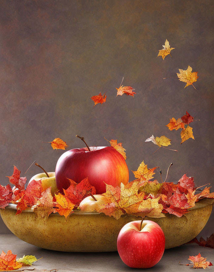 Ripe Red Apples in Golden Bowl with Autumn Leaves on Textured Background