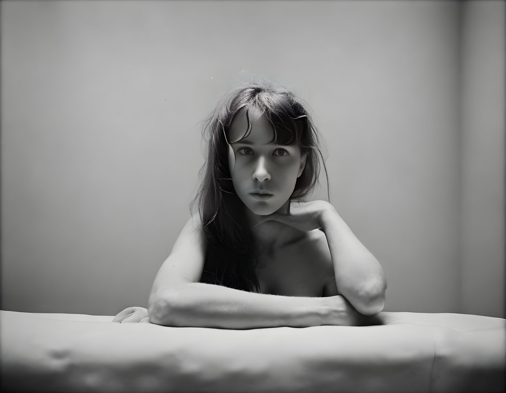 Monochrome portrait of young girl with long hair and thoughtful expression