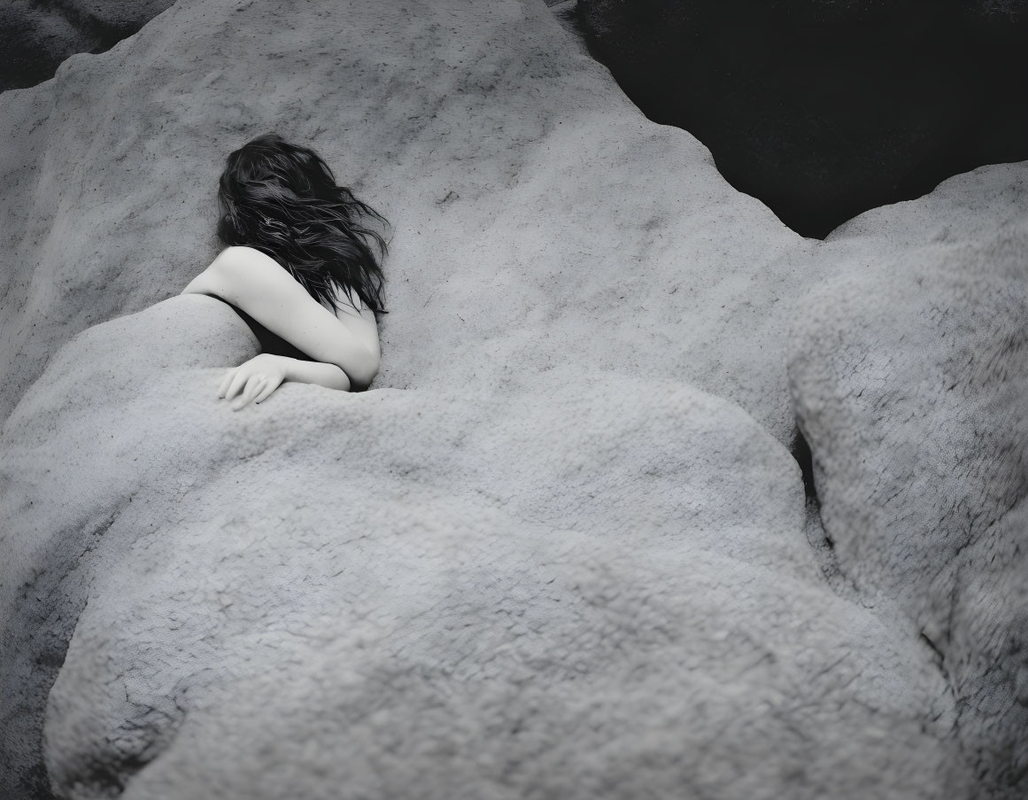 Monochrome aerial photo of person blending with rocky textures