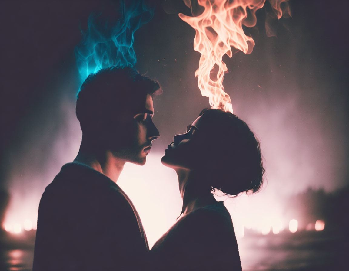 Couple gazing with colorful flames in dark background