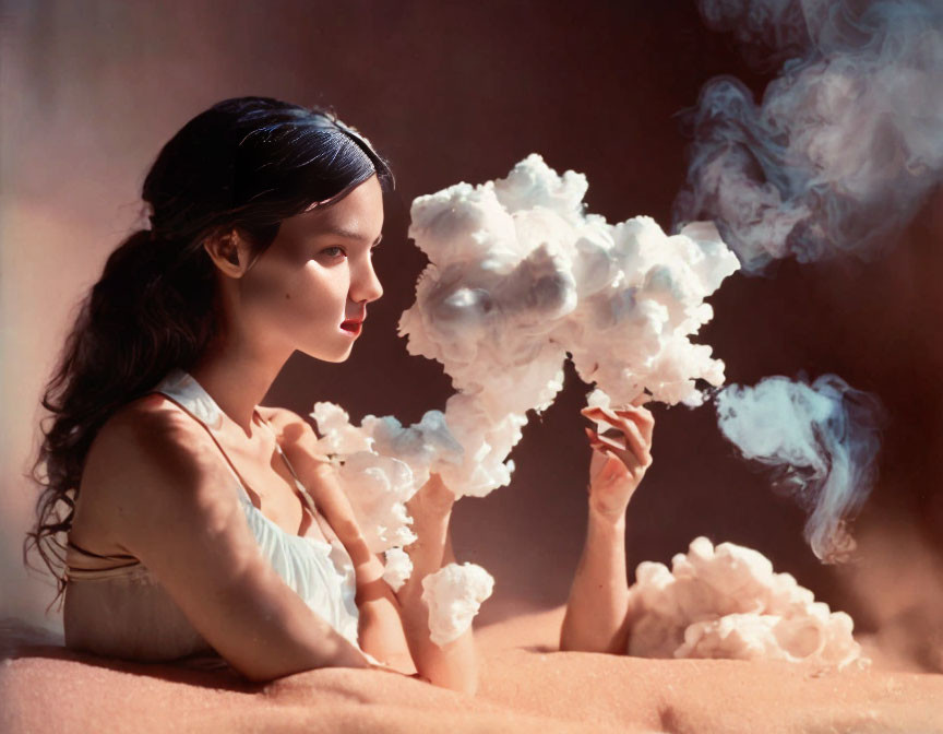 Dark-haired woman gazes at cloud-like formation in dreamlike setting