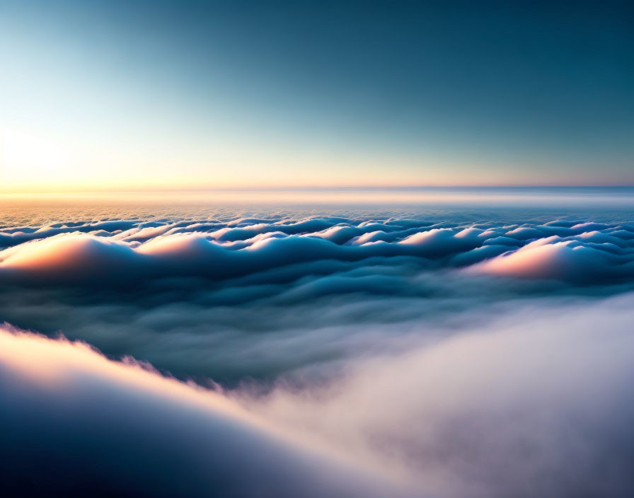 Sunset view above clouds: orange hues on fluffy cloud tops