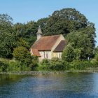 Tranquil countryside cottage with lush trees and serene pond