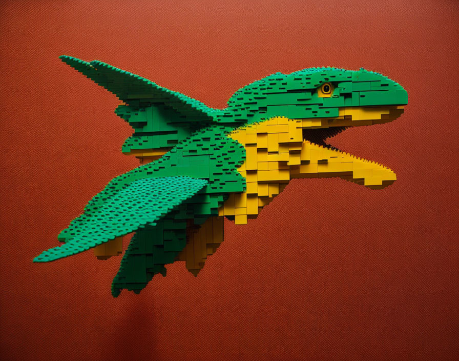 Green and Yellow Lego Bird Sculpture on Red Wall