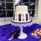 Festive cake with candles, wine glasses, and slice on table by window