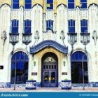 Symmetrical digital building facade with blue doors, geometric patterns, and vibrant floral arrangements