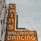 Bright Neon Sign: "Ballroom Dancing" on Cloudy Sky