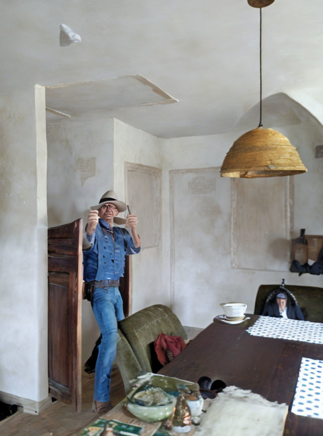 Man in denim jacket and hat photographing rustic room with person at table