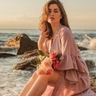 Woman in Pink Dress Sitting in Tall Grass at Sunset