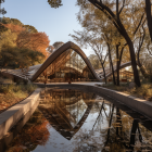 Tranquil lake scene with chapel-like house and autumn trees