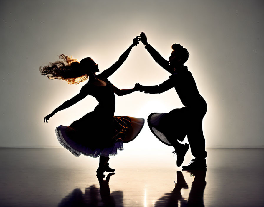 Dynamic silhouetted dancers mid-twirl on bright background