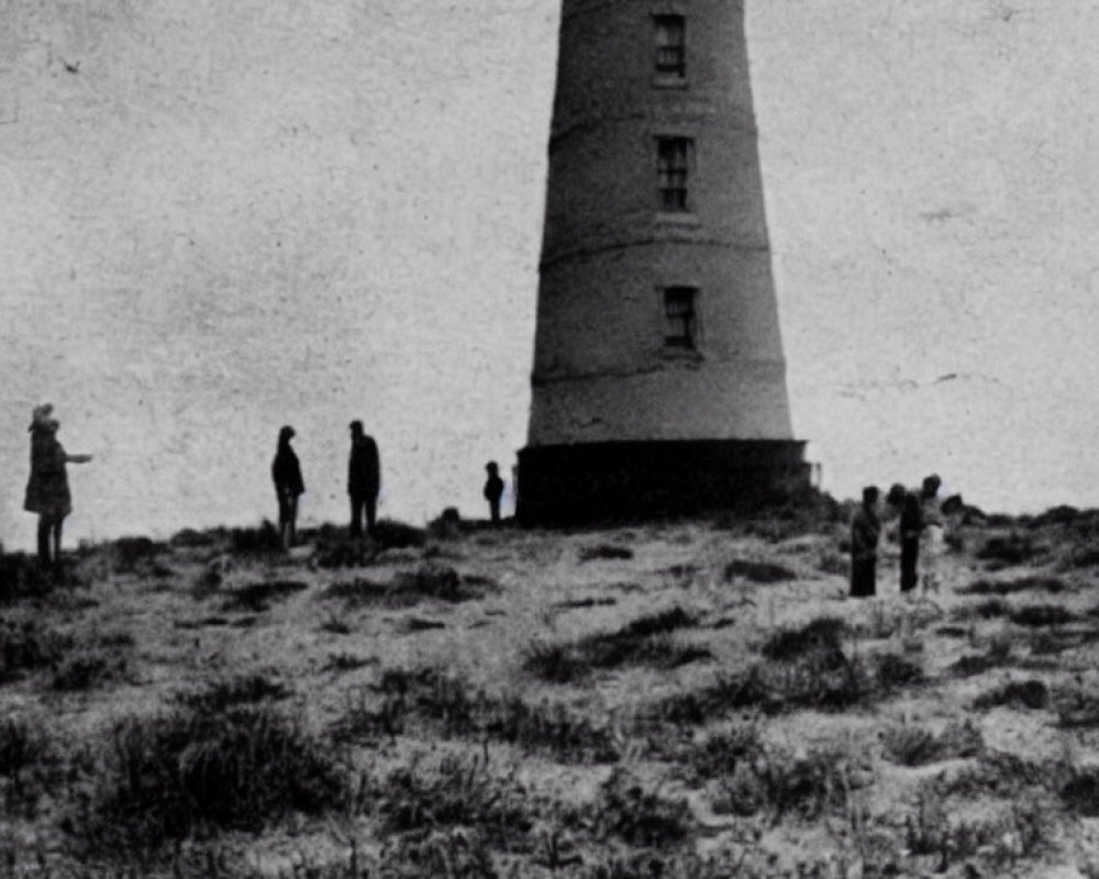 Vintage Black and White Photo: People by Lighthouse in Field