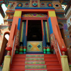 Colorful Temple Entrance with Red Steps and Decorative Motifs