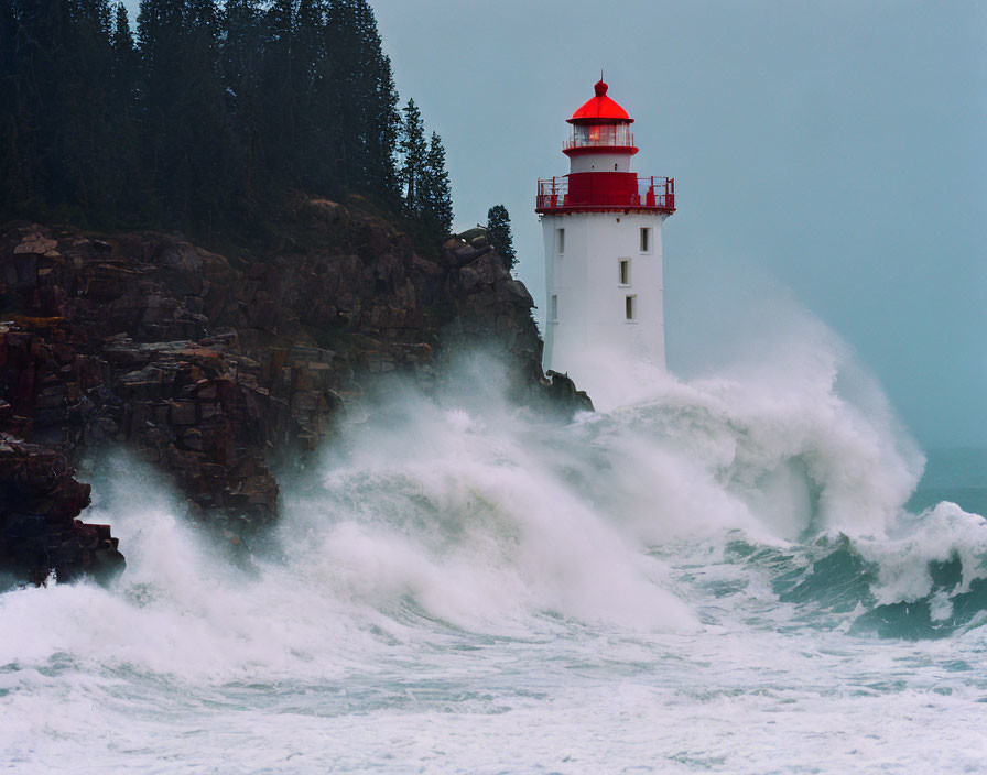 Rocky cliff lighthouse with crashing waves under gloomy sky