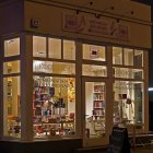 Festive storefront with warm glow and snow ambiance