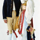 Man and woman in ornate European folk costumes with beard and white headscarf.