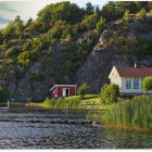 Scenic countryside with white house, red barn, lake, and colorful trees