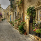 Charming cobblestone alleyway with colorful flowers and pastel houses