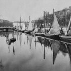 Tranquil harbor scene with colorful sailboats and calm waters