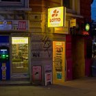 Vibrant neon-lit corner shop with inviting window display at dusk