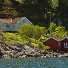 Lighthouse, charming houses, rocky shores in coastal scene