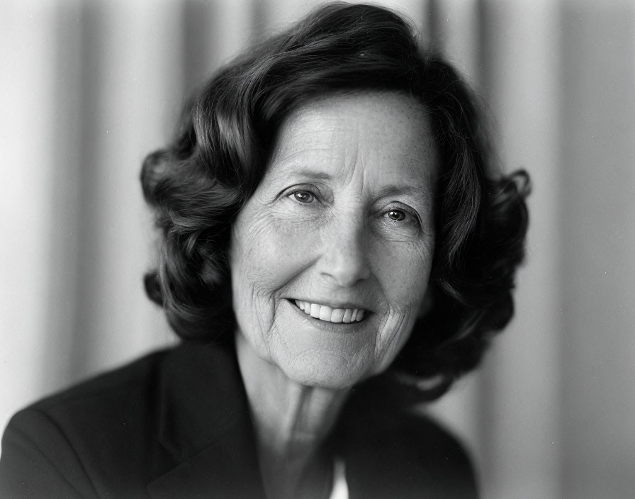 Portrait of elderly woman with warm smile and wavy hair