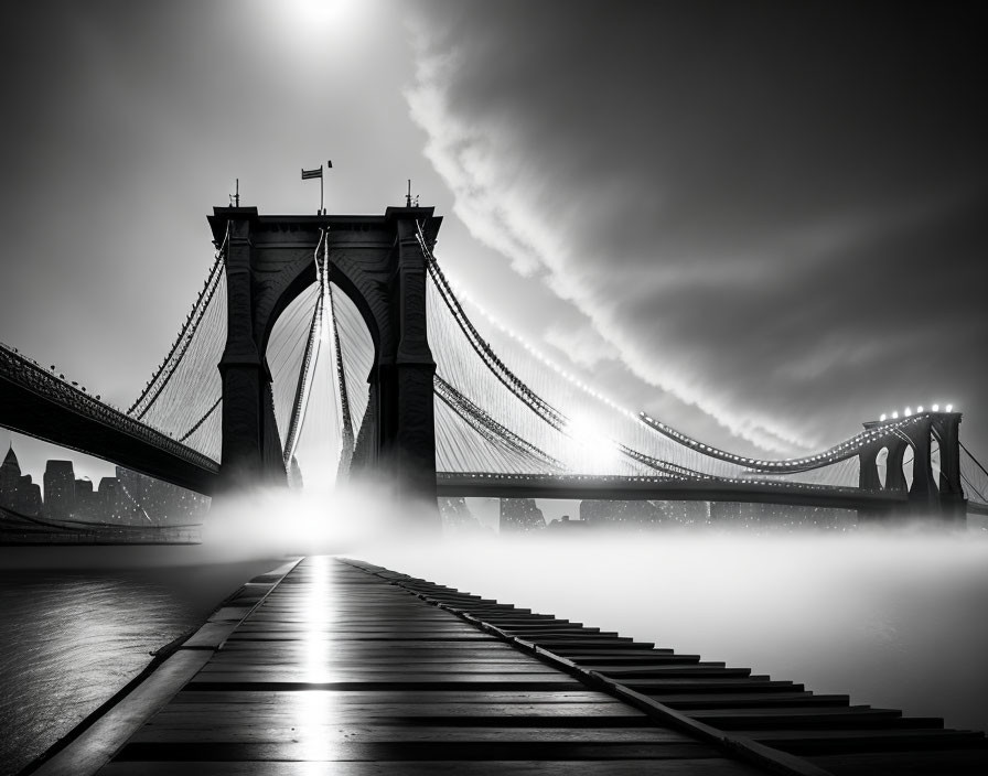 Monochrome Brooklyn Bridge fog scene with dramatic lighting and cloudy skies