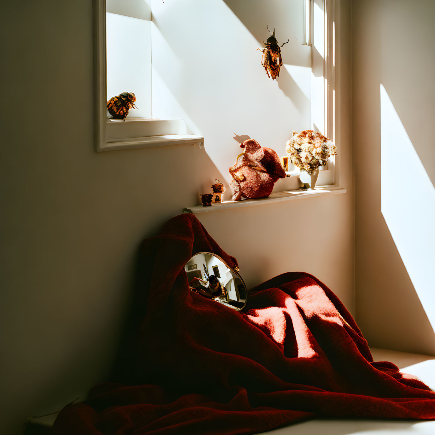 Cozy nook with red blanket, plants, and decor in sunlight