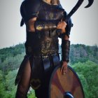 Warrior in Dark Leather Armor with Shield and Axe in Forest