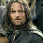 Rugged man with long hair and cloak in natural setting