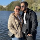 Traditional couple portrait with lakeside village backdrop