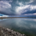 Tranquil landscape with mirror-like lake and dramatic sky