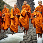 Smiling monks in orange robes jumping over river with green cliffs