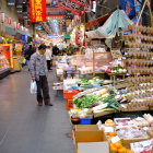 Vibrant market scene with golden lamps and pottery stalls