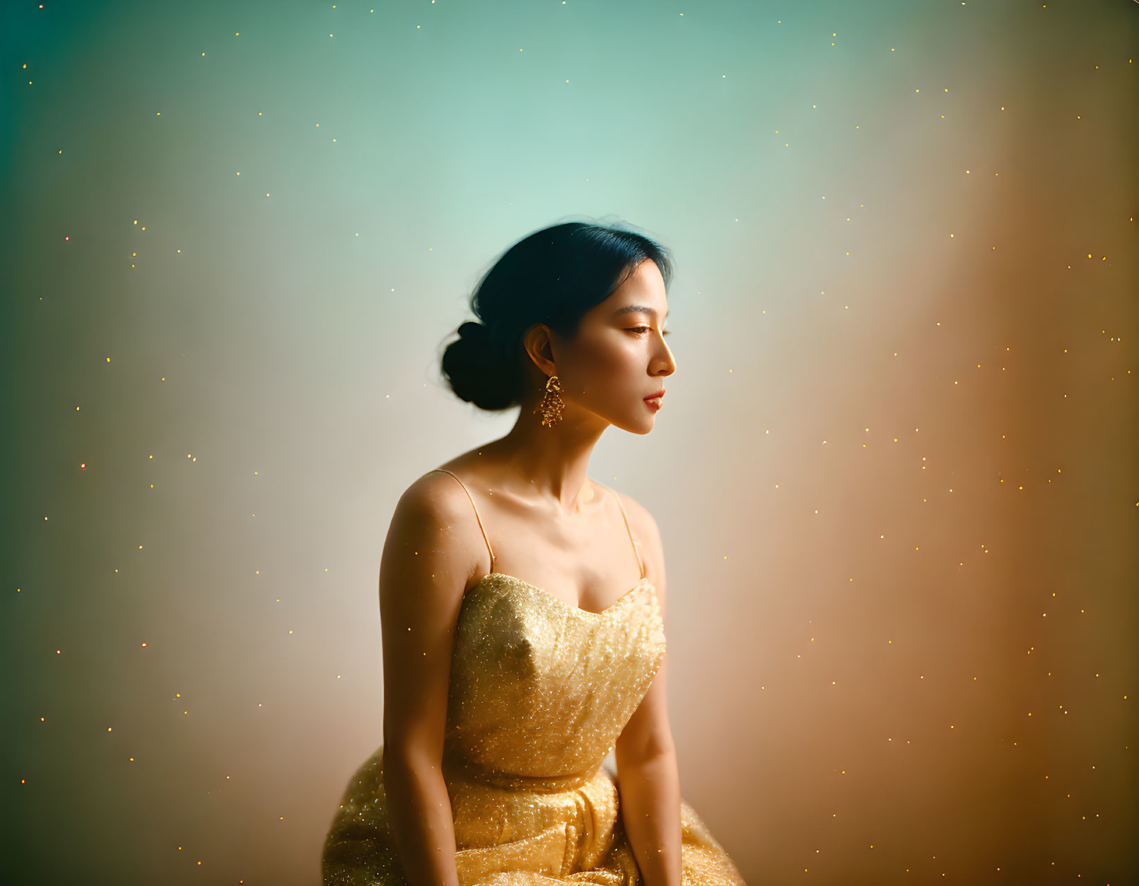 Woman in Golden Dress on Teal Background with Bokeh Sparkles