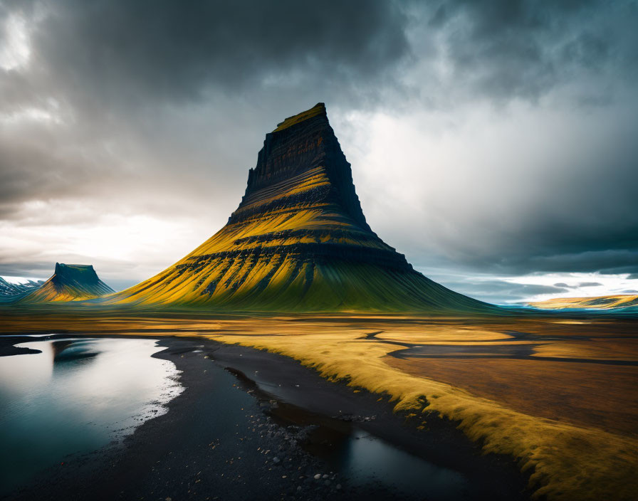 Striated mountain under stormy skies with golden light break