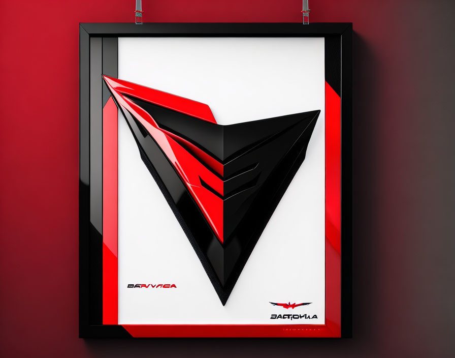 Abstract geometric art: Black and red shapes on framed display against red wall